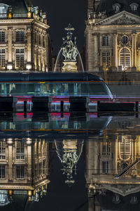 Reflection of building in city at night