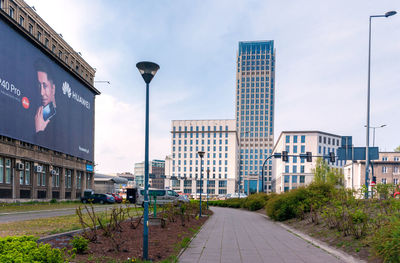 Street amidst buildings against sky in city