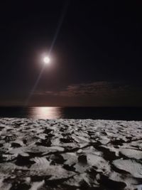 Scenic view of sea against sky at night