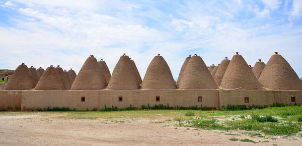 Built structure on field against sky