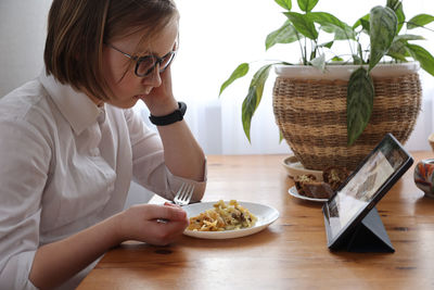 Midsection of woman holding food on table