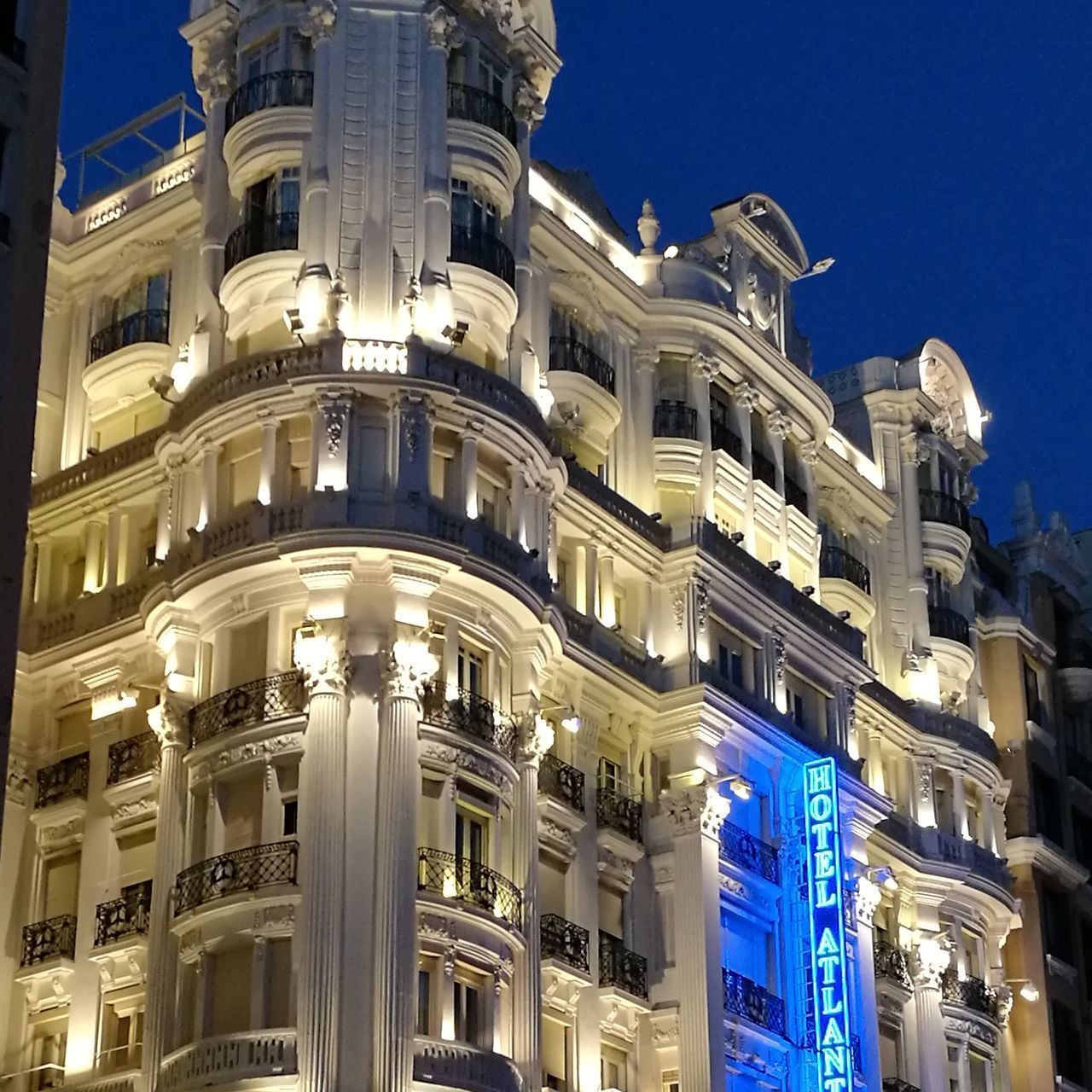 LOW ANGLE VIEW OF BUILDINGS AGAINST BLUE SKY