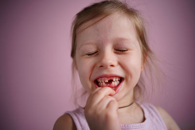 Girl smiles without a front tooth