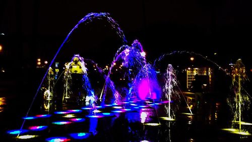 Illuminated ferris wheel at night