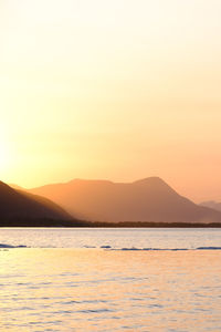 Scenic view of sea against clear sky during sunset