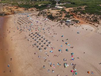 Aerial view of people at beach during sunny day