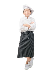 Portrait of a smiling girl standing against white background