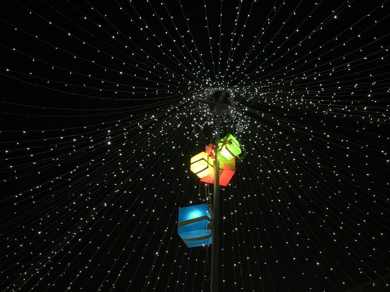 LOW ANGLE VIEW OF ILLUMINATED LIGHTING EQUIPMENT AGAINST STAR SHAPE