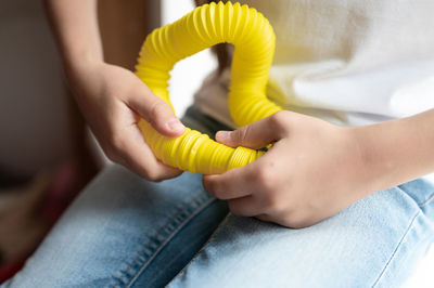 Anti stress sensory pop tube toys in a children's hands. a little kids plays with a poptube toy