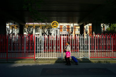 Full length of girl standing against graffiti