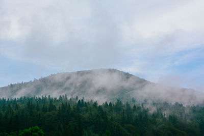 Scenic view of mountains against cloudy sky