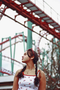 Girl looking away against sky