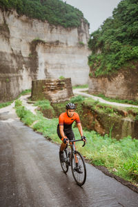 Rear view of man riding bicycle