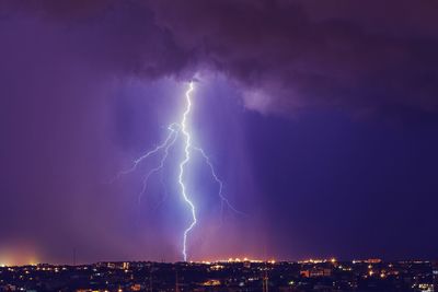 Lightning over cityscape at night