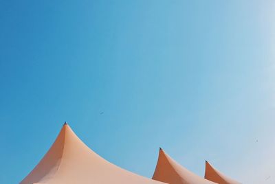 Low angle view of tent against clear blue sky