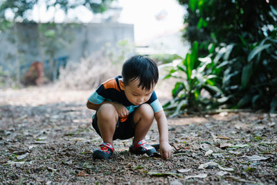Boy sitting on field