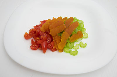 High angle view of chopped vegetables in plate on table