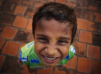 High angle portrait of boy standing on footpath