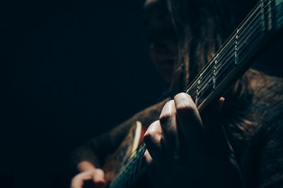 Close-up of man playing guitar