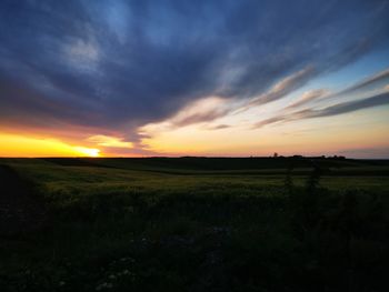 Scenic view of field against sky during sunset