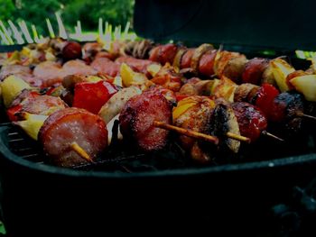 Close-up of skewers and sausages on barbecue grill
