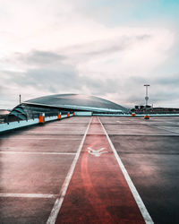 Surface level of airport runway against sky