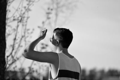 Man shielding eyes during sunny day