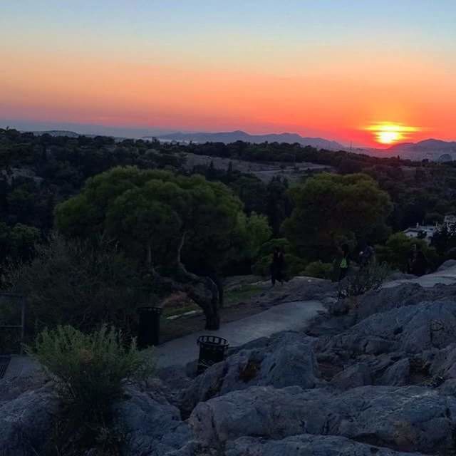 sunset, orange color, tranquil scene, sun, scenics, tranquility, beauty in nature, landscape, tree, nature, idyllic, sky, mountain, sunlight, clear sky, non-urban scene, hill, field, high angle view, outdoors