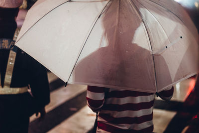 Rear view of woman with umbrella