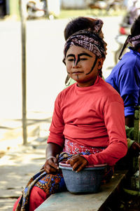 A street dancer child is sitting