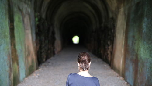 Rear view of woman in tunnel