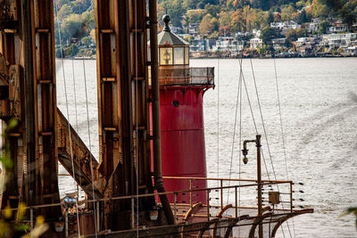 Sailboats in sea by buildings