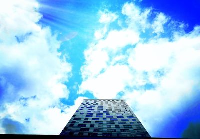 Low angle view of skyscrapers against blue sky