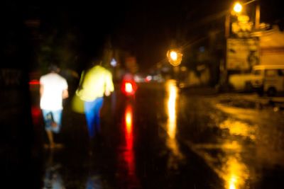 Defocused image of people in city at night