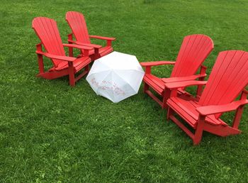 Empty chairs on grass