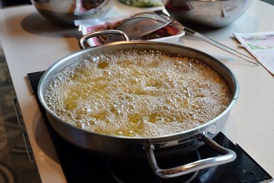 High angle view of food cooking on induction stove in kitchen