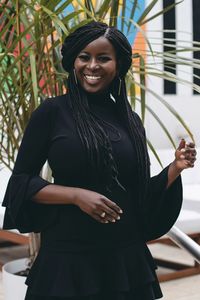 Portrait of smiling mid adult woman standing outdoors