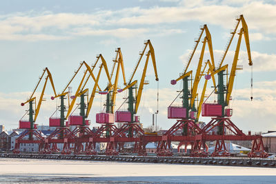 Massive harbor cranes in seaport. heavy load dockside cranes in port, cargo container ship terminal