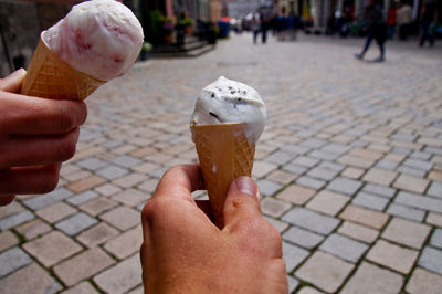 Close-up of hand holding ice cream cone