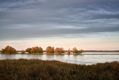 Scenic view of lake against sky during sunset