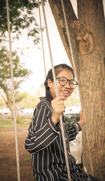 Portrait of teenage girl on swing