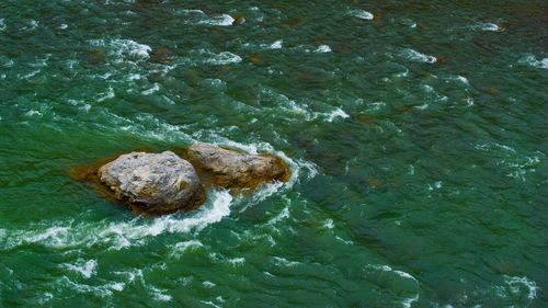 High angle view of  rock by sea