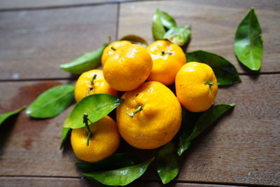 High angle view of fruits and leaves on table