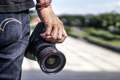 Midsection of photographer holding camera