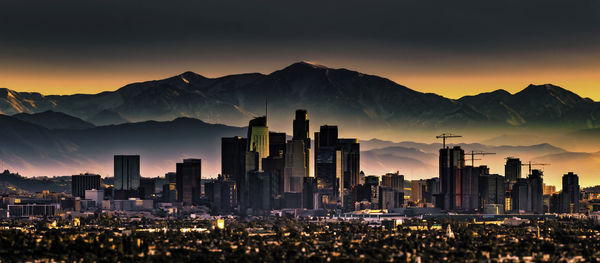 Panoramic view of city against sky during sunset