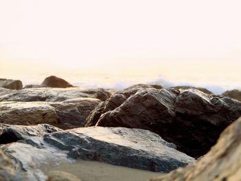 Close-up of rocks against sky during sunset