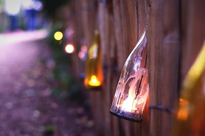 Close-up of illuminated lighting equipment on pathway at night