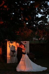 View of newly wed couple embracing outdoors