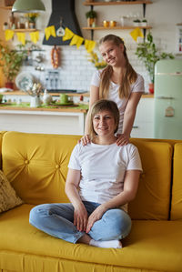 Happy family sitting on sofa at home