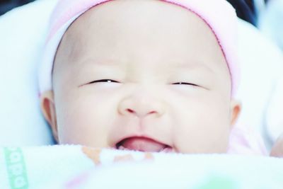 Close-up of cute baby on bed